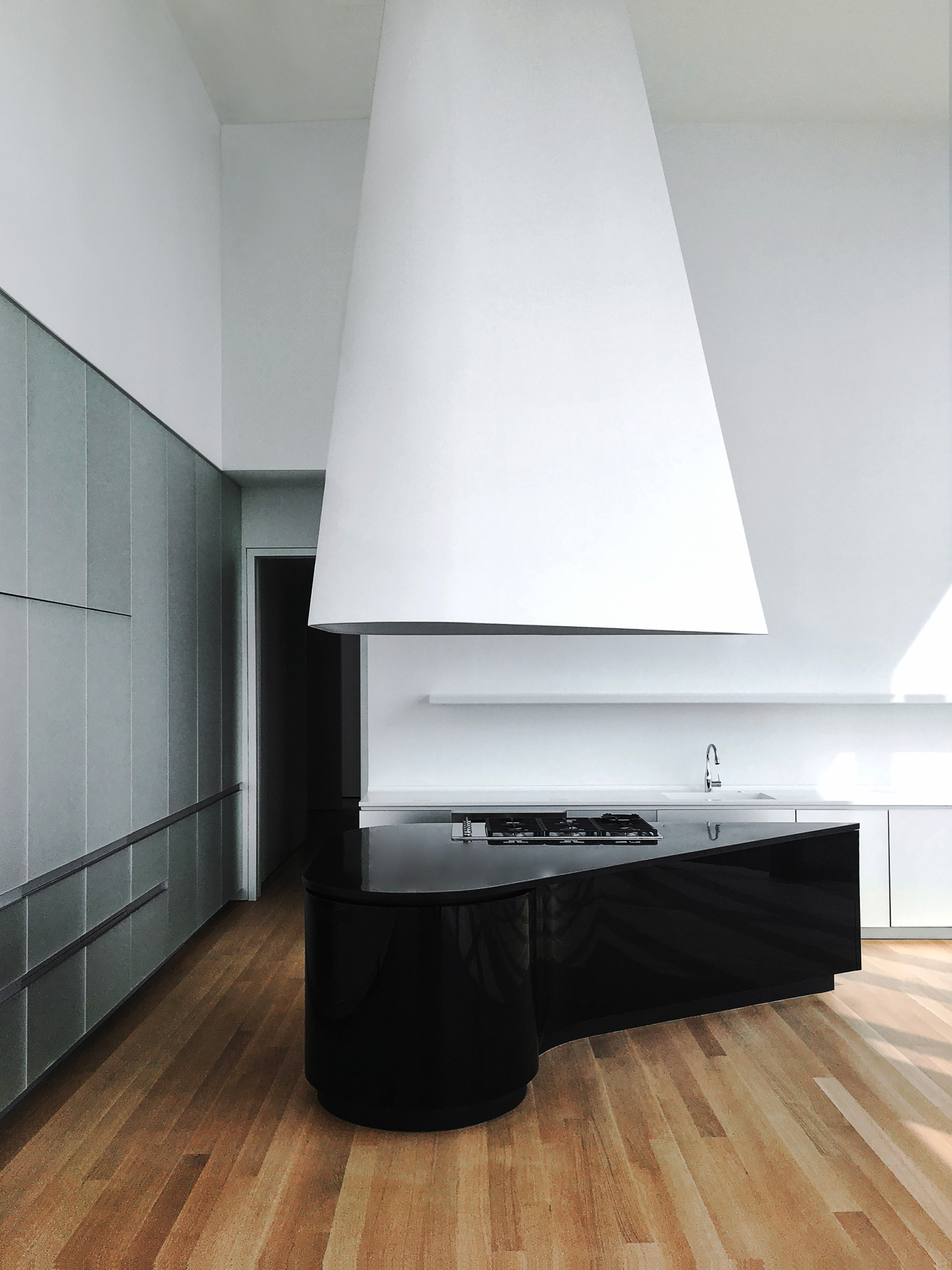 One of the custom-made kitchens at 56 Leonard Street in New York, based on a design by Herzog & de Meuron, featuring black islands with original granite countertops