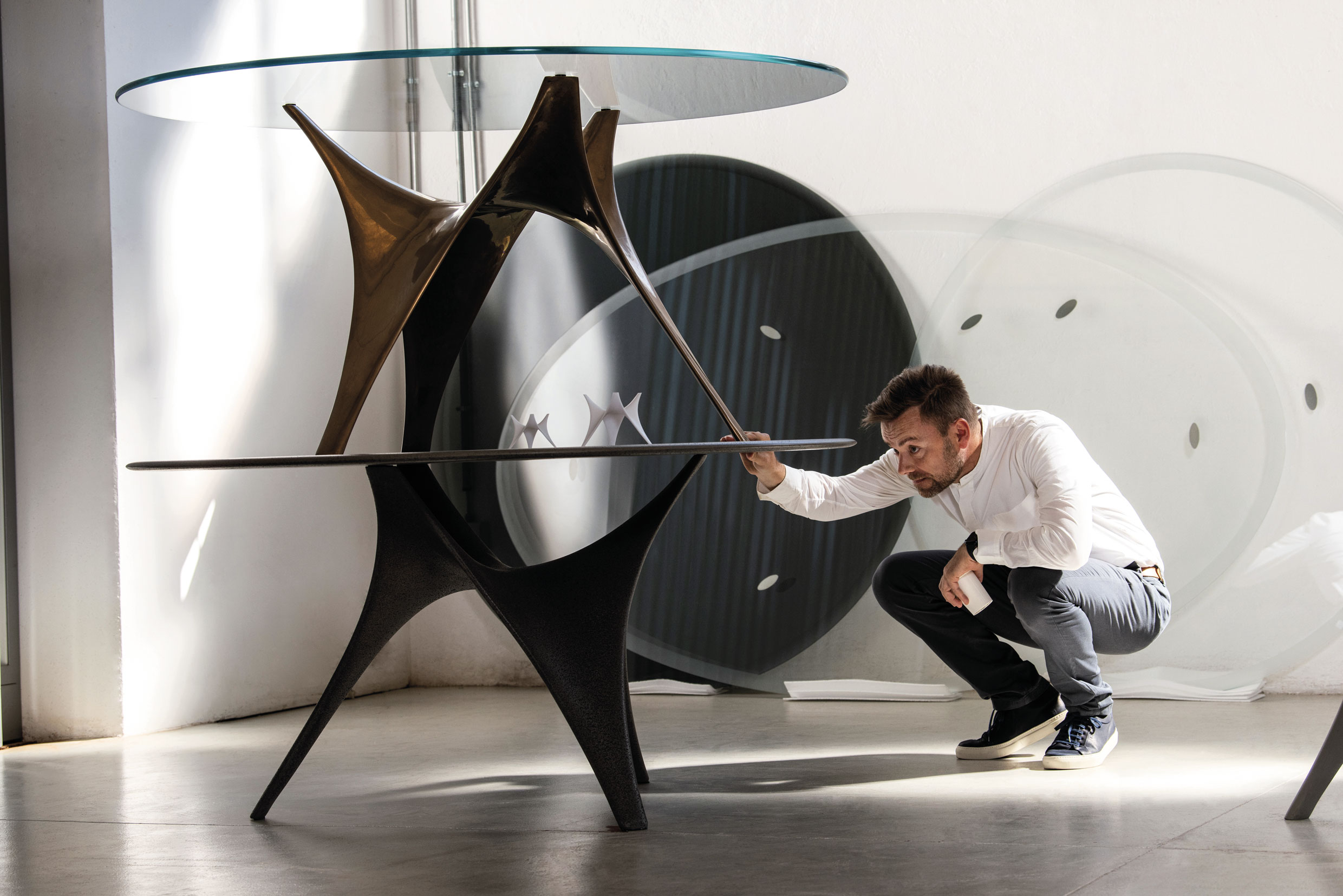 Mike Holland from Foster + Partners ; sketches and prototypes of Arc Table. From Molteni Mondo, Rizzoli NY 2024. Ph. Jeff Burton